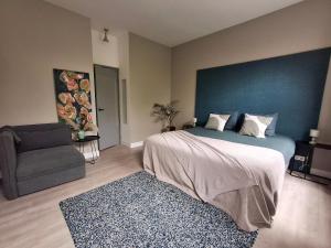 a bedroom with a large bed and a chair at Inn the Green in Zeist
