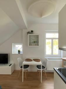 a kitchen with a table and chairs in a room at Altstadt-Apartment in Bad Laasphe +2 photos