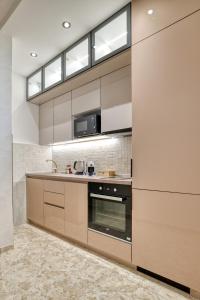 a kitchen with a stove and a microwave at Apartments Elena in Budva