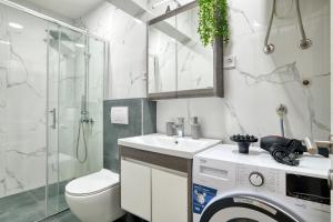 a bathroom with a toilet sink and a shower at Apartments Elena in Budva