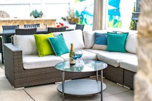 a couch and a glass table with a bottle of wine at Upscale Beach Cottage a Block to the Beach Sauna in Encinitas +39 photos