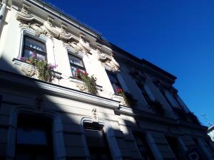 un edificio con dos ventanas con flores. en Apartmány - Penzion Smetanka, en České Budějovice