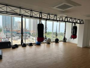 a room with boxing equipment in front of a large window at Loft en frente de la playa, Bello Horizonte in Santa Marta