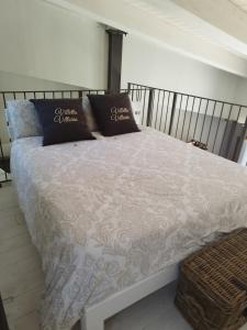 a bed with two pillows on top of it at Villetta Vittoria Country House. La depandance in Pennabilli