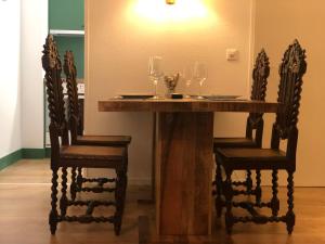 a wooden table with two chairs and wine glasses at Fortuna in Leukerbad
