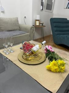 a bottle of wine on a table in a living room at Big Apartment Veles in Veles