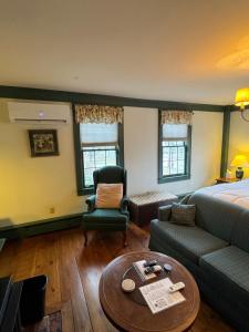 a hotel room with a bed and a couch and a table at Chester Inn in Chester