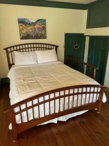 a large bed in a bedroom with a painting on the wall at Chester Inn in Chester