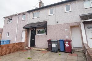 a brick house with three trash cans in front of it at Quiet 3 bed house, pet friendly in Kirkby