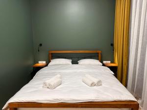 A bed or beds in a room at Hotel Mountime Kazbegi
