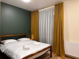 A bed or beds in a room at Hotel Mountime Kazbegi