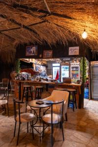 a restaurant with tables and chairs and a bar at Garden Villa Lake Side & Glamping in Ksamil
