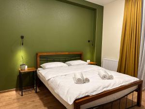 A bed or beds in a room at Hotel Mountime Kazbegi