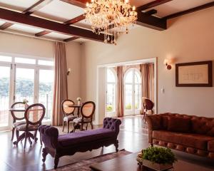 a living room with a couch and a table at Castelo Boutique Hotel in Fraiburgo