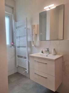 a bathroom with a sink and a mirror and a shower at Crystal Apartment Umag in Umag +17 photos