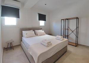 a bedroom with a bed with two towels on it at K78 Studios A1 in Nea Michaniona