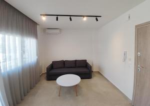 a living room with a couch and a table at K78 Studios A1 in Nea Michaniona