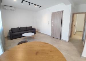a living room with a table and a couch at K78 Studios A1 in Nea Michaniona
