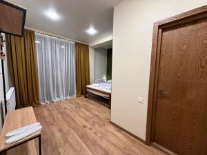 A bed or beds in a room at Hotel Mountime Kazbegi