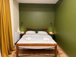 A bed or beds in a room at Hotel Mountime Kazbegi