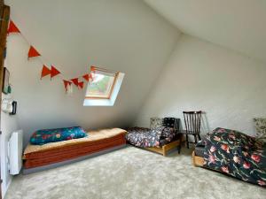 LanvellecにあるMaison entre campagne et merの屋根裏部屋(ベッド2台、椅子付)