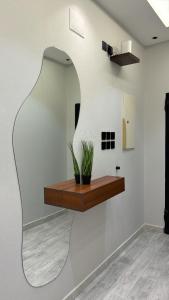 a room with a wooden shelf on the wall at شقة فندقيه Happy Season in Khamis Mushayt