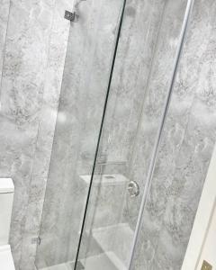 a shower stall with a glass shower door at Hayati HOTEL in Samarkand +52 photos