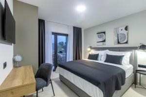 a bedroom with a bed and a desk and a television at Villa Mare in Vinišće +56 photos