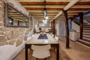 a dining room with a table and chairs and a mirror at Villa Veselici in Labin
