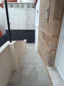 an empty hallway with a brick wall and a door at Casa Miguel in Teis