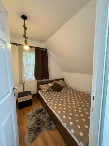 a small bedroom with a bed in a attic at Woodland house in Sîntimbru-Băi