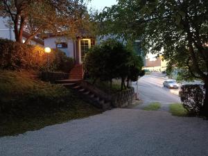 a house with a staircase leading to a driveway at Prenociste Cazin in Cazin