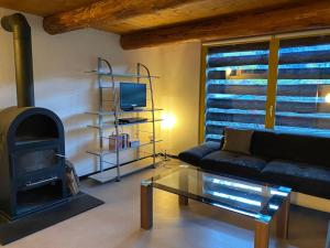 a living room with a couch and a fireplace at Rustico sui Monti di Rima in Broglio