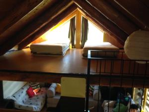 two beds sitting on top of a attic room at Rustico sui Monti di Rima in Broglio