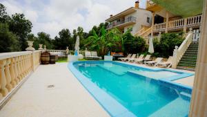 a swimming pool in front of a house at La Casa de Mima in Cubelles