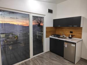 a kitchen with a large window with a view at Apartment DULE Trpejca in Ohrid