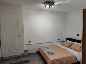 a bedroom with a bed with two towels on it at Apartment DULE Trpejca in Ohrid