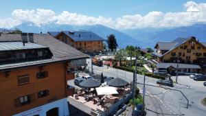 a view of a town with mountains in the background at Moo-ntain Suite by Villars Luxury in Villars-sur-Ollon +4 photos