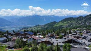 a town in a valley with mountains in the background at Moo-ntain Suite by Villars Luxury in Villars-sur-Ollon
