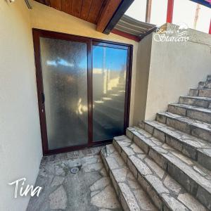 a glass door on a house with stairs at Apartmani Konoba Starčevo in Virpazar