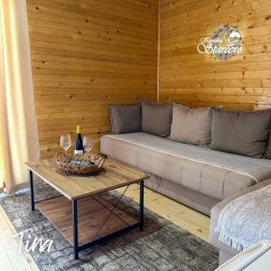 a living room with a couch and a table with wine glasses at Apartmani Konoba Starčevo in Virpazar