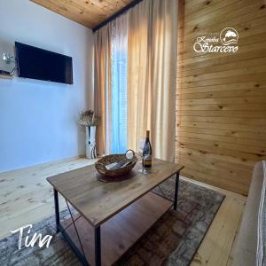 a living room with a table with a bottle of wine at Apartmani Konoba Starčevo in Virpazar