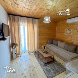 a living room with a couch and a table at Apartmani Konoba Starčevo in Virpazar