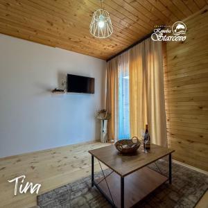 a living room with a table and a tv at Apartmani Konoba Starčevo in Virpazar