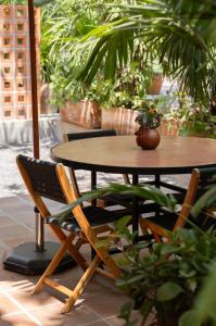 a table and chairs with a potted plant on a patio at La Paranera Hotel & Relax in Comala