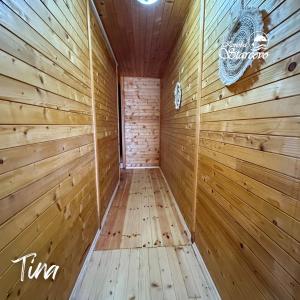 a sauna with wooden walls and a chandelier at Apartmani Konoba Starčevo in Virpazar