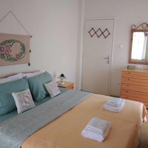 a bedroom with a large bed with two towels on it at Lydia Home in Kavala