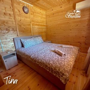a bedroom with a bed in a wooden cabin at Apartmani Konoba Starčevo in Virpazar
