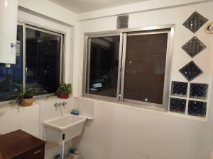 a bathroom with a sink and two windows at Camba Cua Relax in Corrientes +14 photos