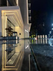 a building with a swimming pool at night at Next Apartments Batumi with Sea View in Batumi